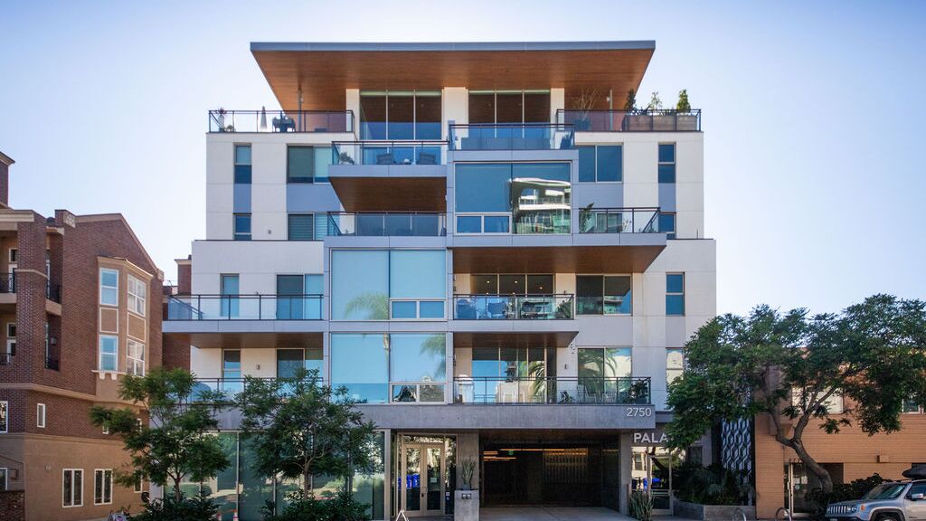 Modern residential building with integrated parking system access, spacious balconies, and high-quality architecture.