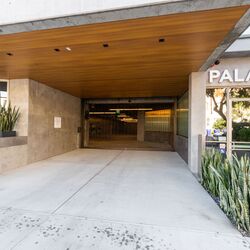 Modern entrance to a residential building with an integrated parking system.